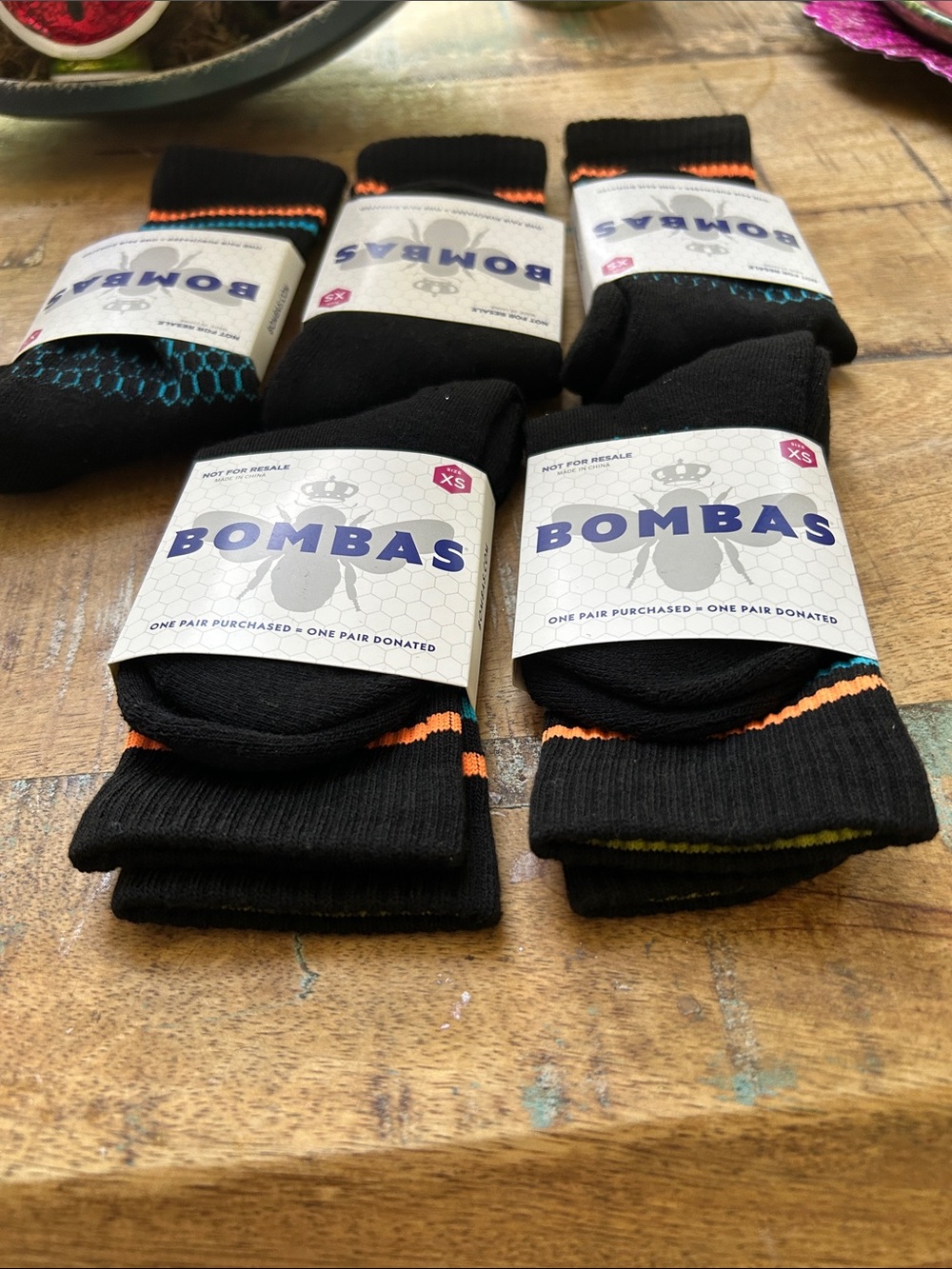 Bombas Black Crew Socks with Orange, Blue, and Yellow Accents